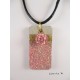 Shamballa bead necklace pendant pink on concrete pedestal decorated rectangle glittery pink and gold metal sheet