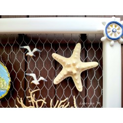 Painting of painted shells, coral, starfish, white wooden frame