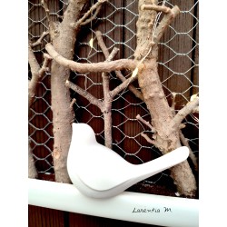 White frame with illuminated branches and white ceramic bird