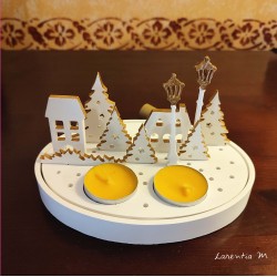 Christmas village with candles and fairy lights