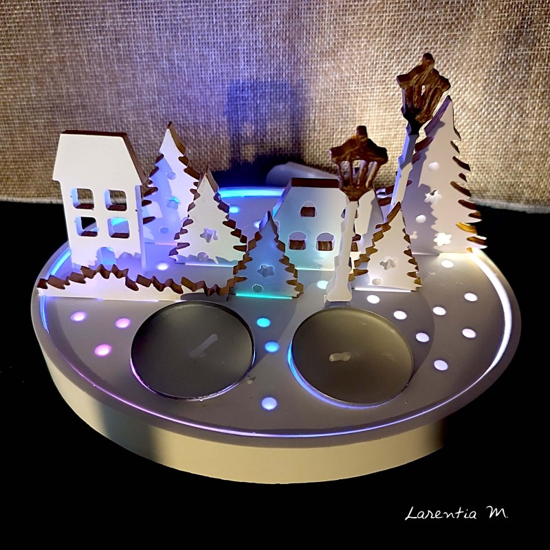 Christmas village with candles and fairy lights