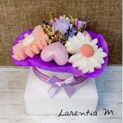 Bouquet of flower candles in a box with dried flowers and ribbon