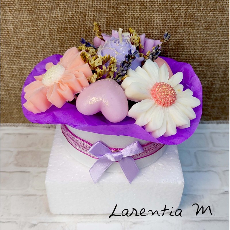 Bouquet of flower candles in a box with dried flowers and ribbon