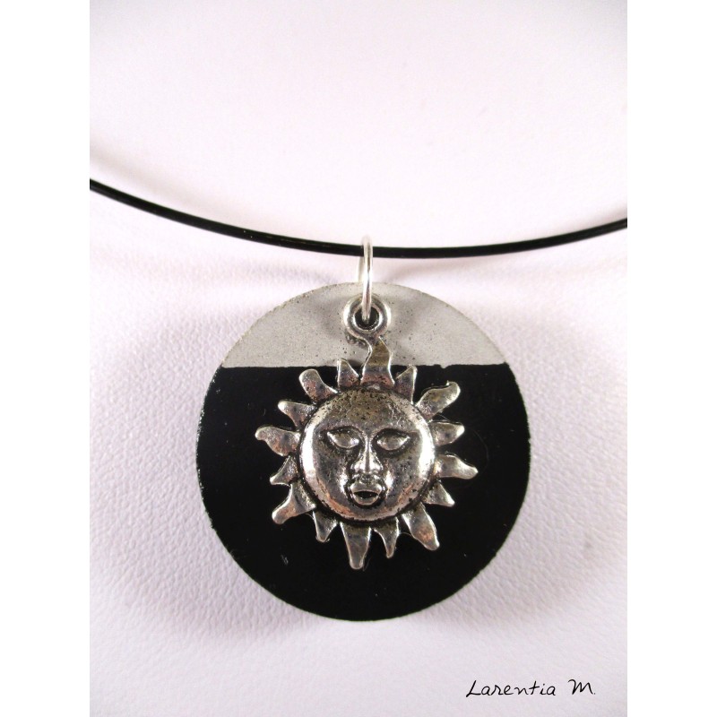 Black necklace with round black concrete and silver sun