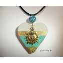 Necklace with golden sun, hanging from a shamballa blue bead on heart concrete glittery and gilded metal sheet